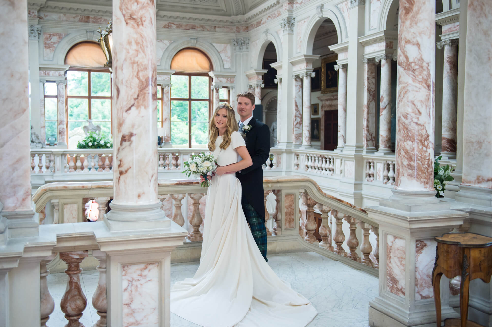 A bride and groom in the great marble hall at gosford house during their wedding reception by especially amy wedding photography